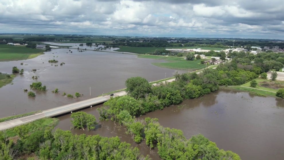 O’Brien County Emergency Management officials shared drone video that shows cars driving over a bridge as water from an overflowing Floyd River in Sheldon, Iowa, continues.